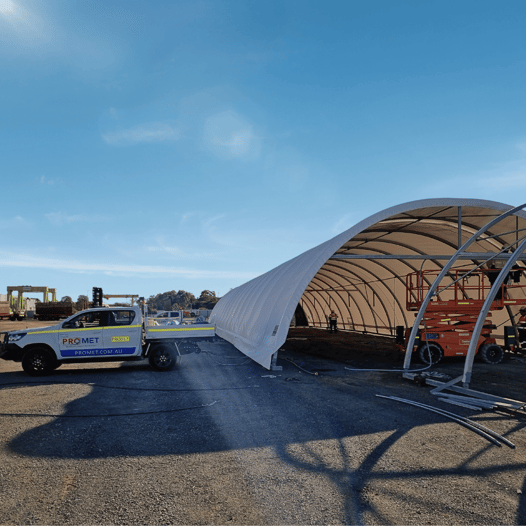 Promet team using their vehicle to remove cover off dome shelted work area